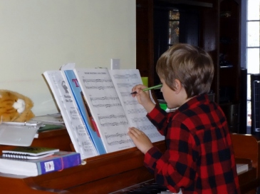 Middle Boy trying his hand at composing
