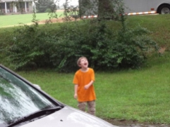Middle Boy catching rain drops